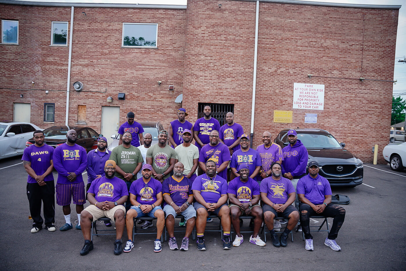 Beta Iota brothers in purple and gold, seated and standing together at a chapter fellowship